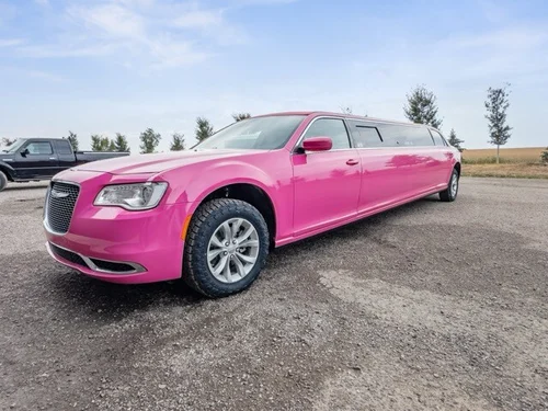 image of 10 passenger pink Chrysler limousine front driver side angle