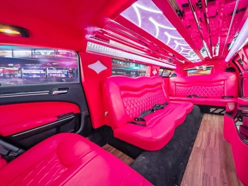 image of 10 passenger pink Chrysler limousine interior taken from rear seat passenger side